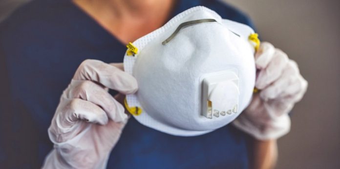 Doctor wearing protection face mask and latex gloves against coronavirus. Banner panorama medical staff preventive gear.