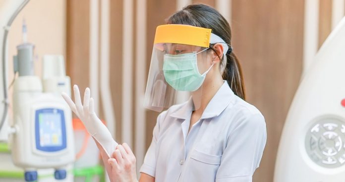 Medical staff wearing face shield, medical mask and medical grov